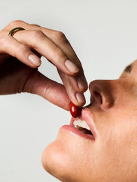 Femme prenant 2 gélules du Soin Préparateur Essentiel.