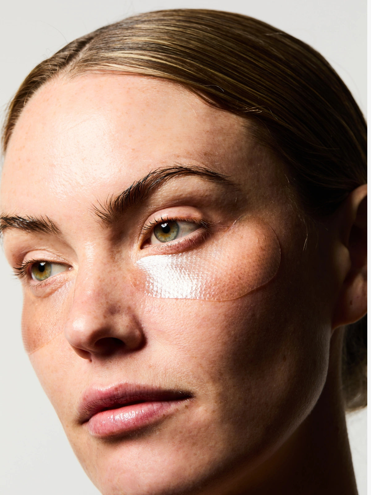 Routine de soin avec les Patchs Hydra-collagène de couleur transparante, parsemés de nacres et de paillettes argentés.