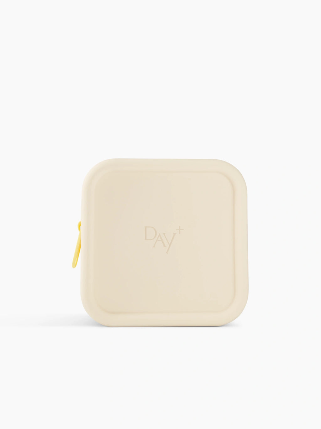 Trousse de voyage Day+ beige avec une fermeture jaune pastel.